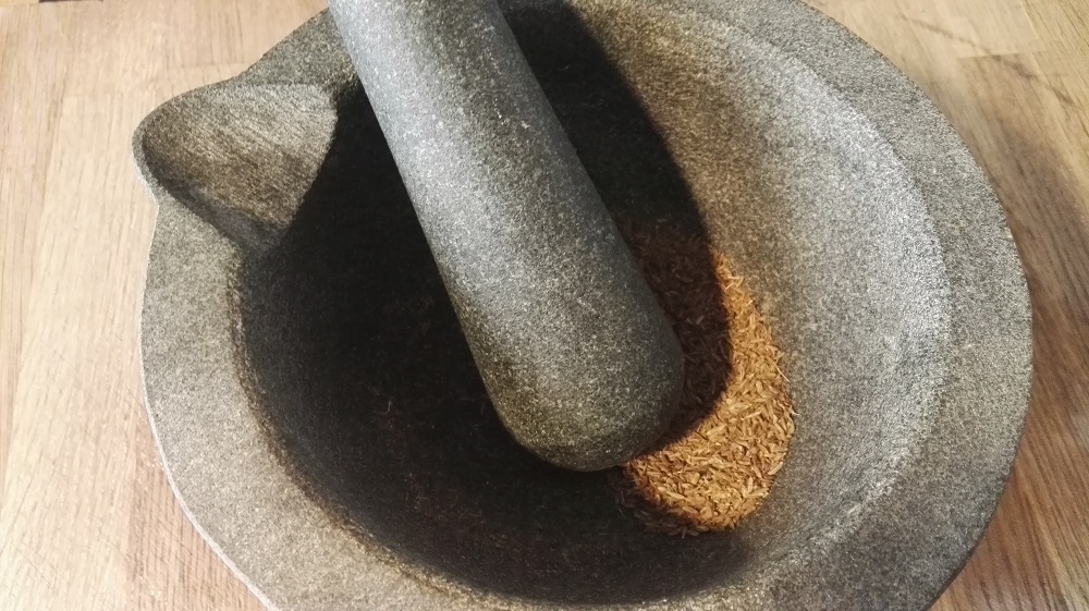 Mortero de granito moliendo comino