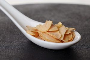 Ajo deshidratado en escamas en una cuchara